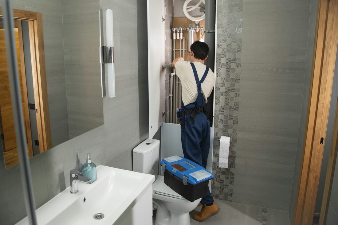 A Drips & Drains technician working on residential plumbing